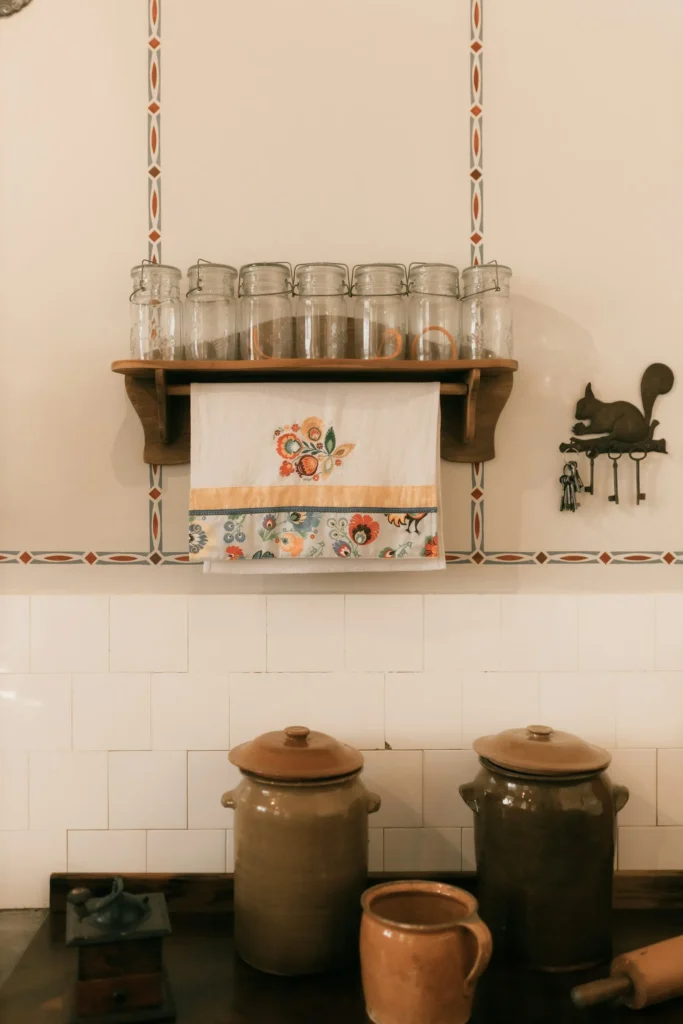 Kitchen shelf with glass jars and a linen tea towel